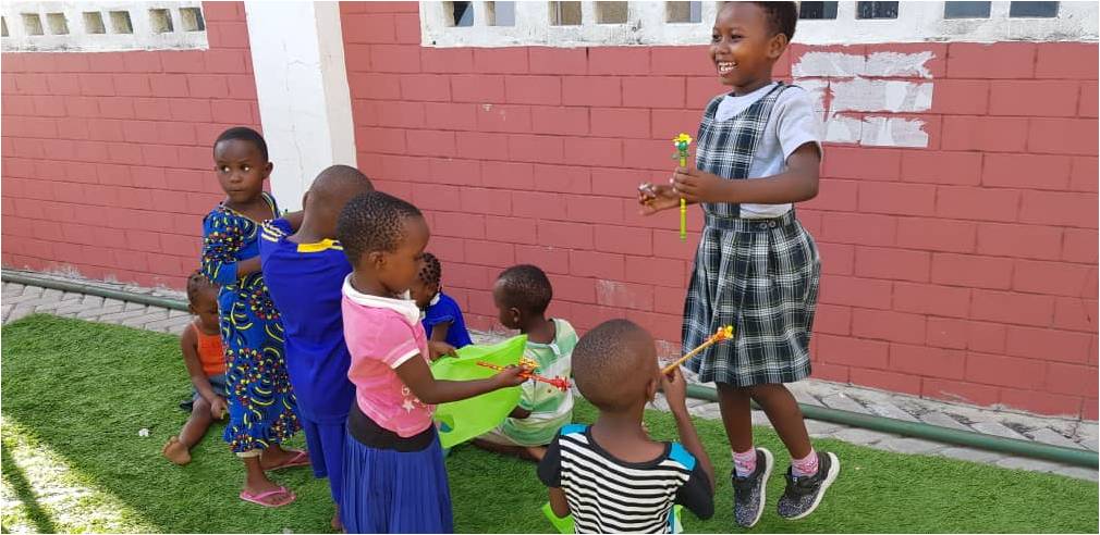 Little children enjoying playing with toys from Time To Help at Dar es Salaam