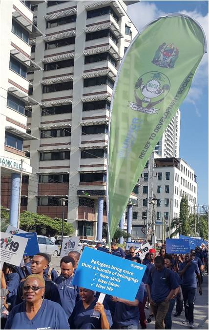 REDESO staff with banners participating peaceful procession during the world refugee day in Dar es Salaam