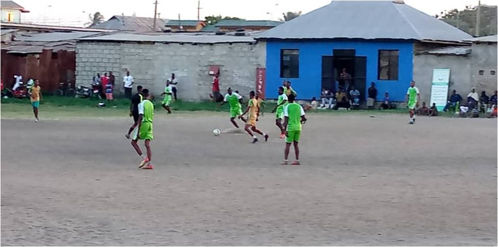 Refugee youth and host community youth in action during the match.