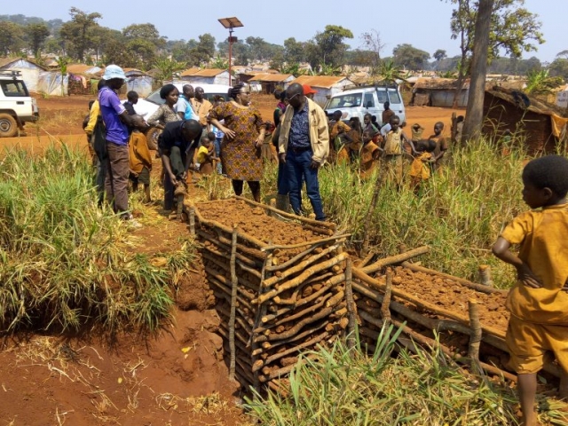 UNHCR representative and REDESO CEO Inspecting and learning Wood gabions technique, used to prevent soil erosion implemented at Mtendeli Camp in Kakonko District